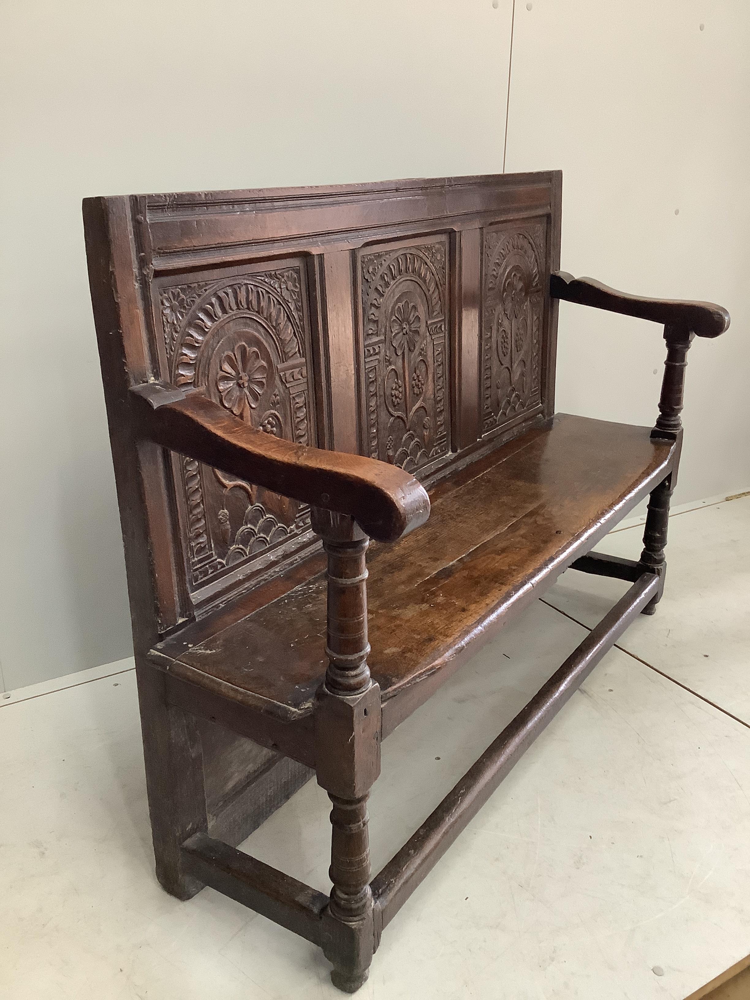 An 18th century style oak settle, incorporates old timber, width 130cm, depth 44cm, height 99cm